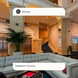 a lobby with a couch and a plant