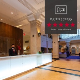 a lobby with a man standing at a desk