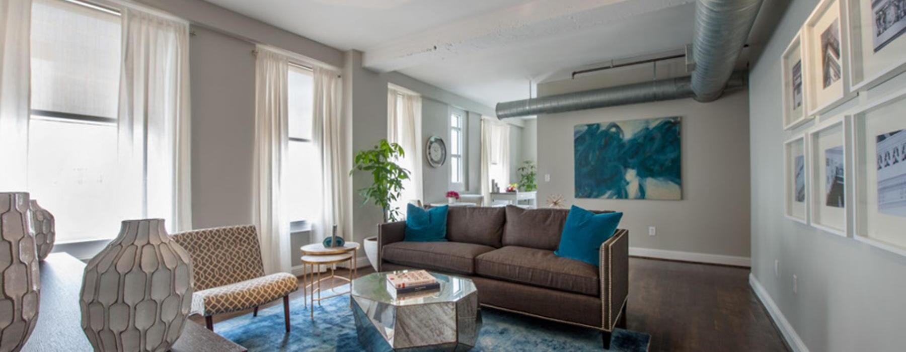 a living room with a rug and a couch