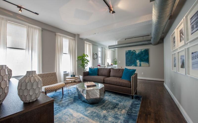 a living room with a rug and a couch