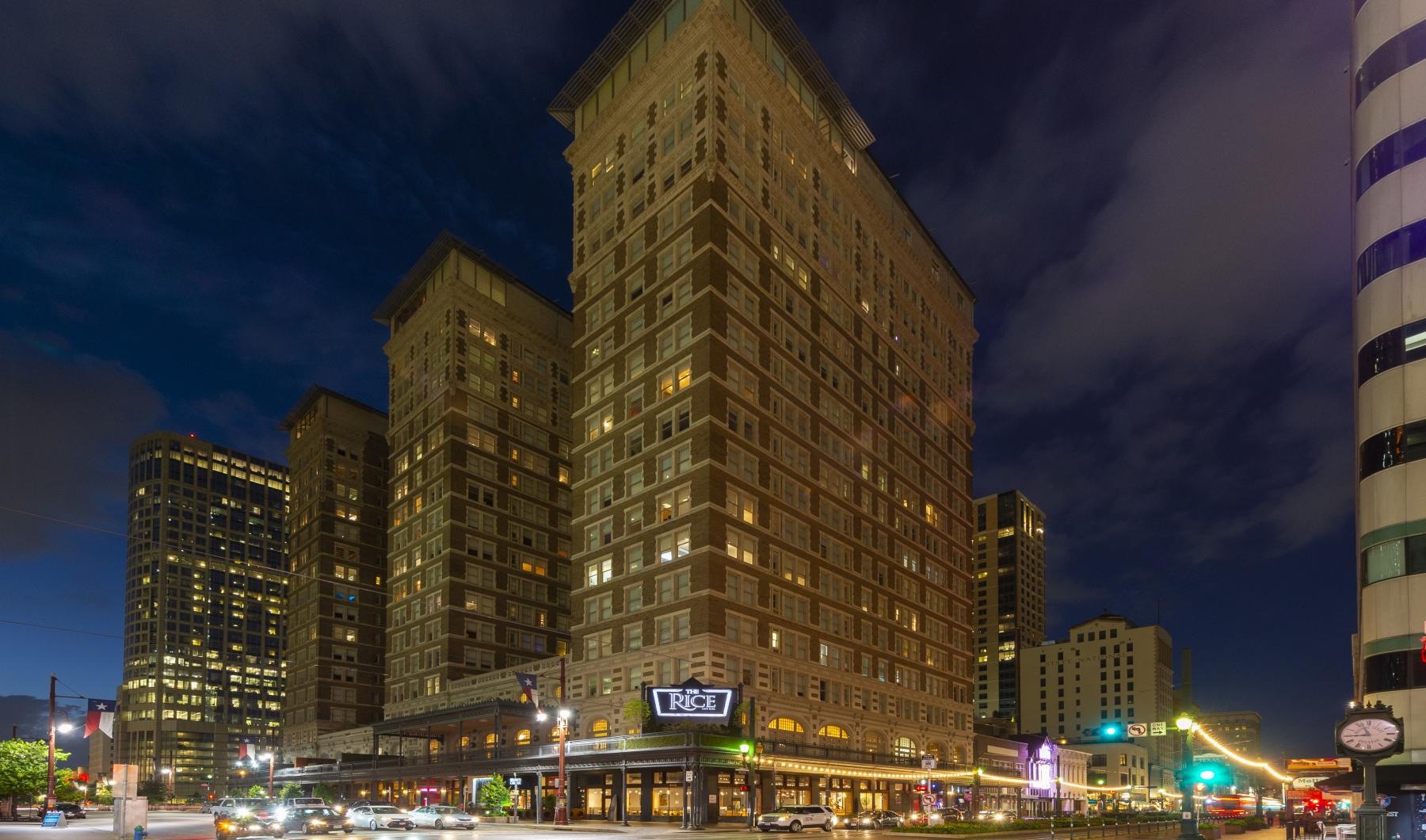 a tall building with many windows with Veer Towers in the background